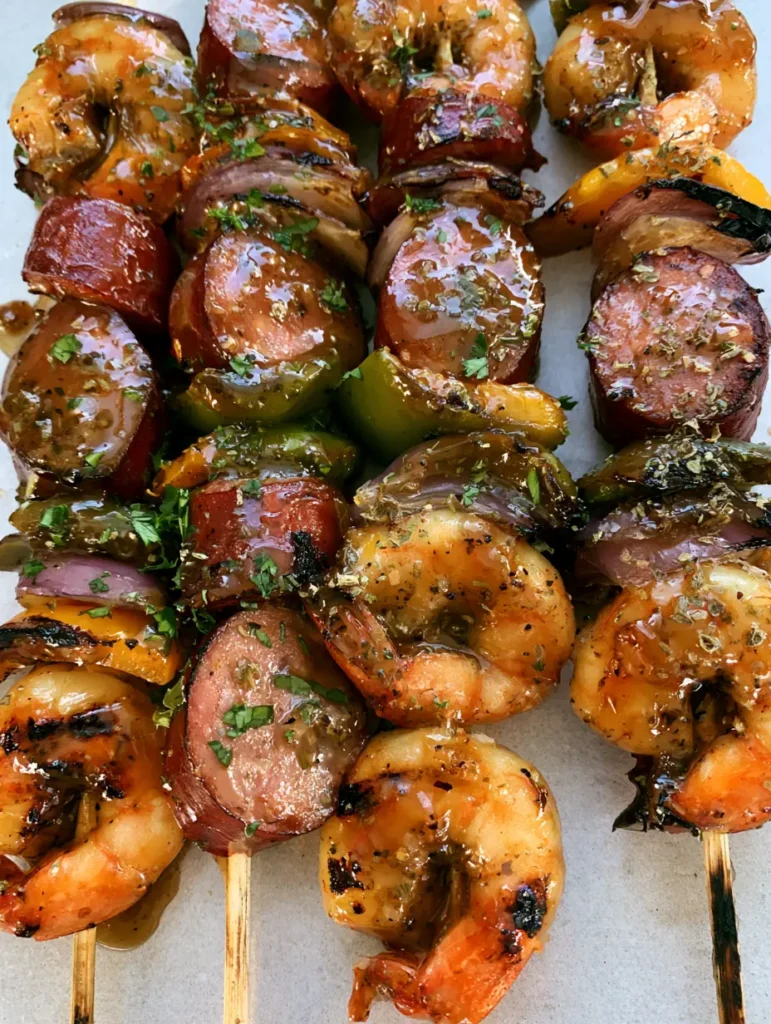 Grilled Seafood Skewers with Smoked Sausage and Garlic Herb Glaze 1 Close up of the translucent amber herb glaze on Grilled Seafood Skewers with visible oregano and black pepper.