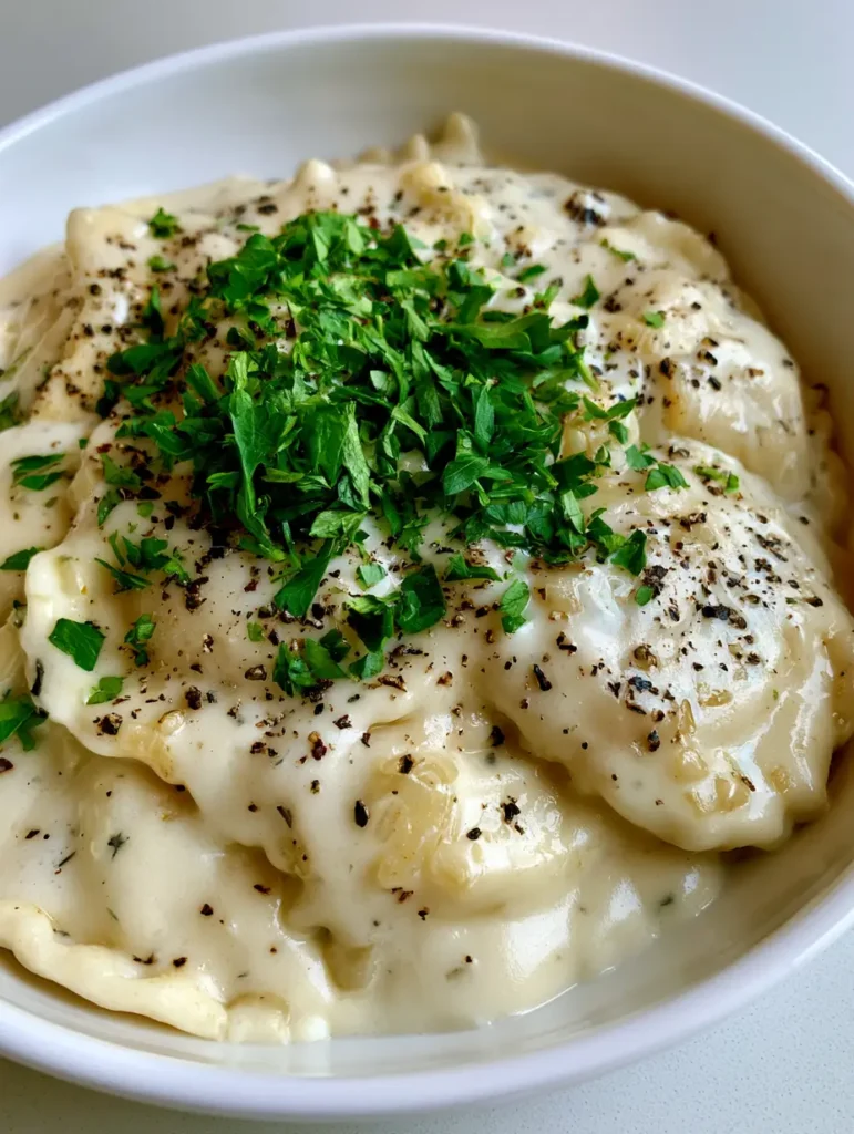 Garlic Parmesan Ravioli Sauce: The Ultimate Creamy 15-Minute Recipe 1 Top-down view of Garlic Parmesan Ravioli Sauce garnished with bright green flat-leaf parsley and coarse black pepper.