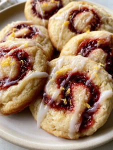 High-angle close-up of thick Lemon Raspberry Cookies showing the crumb texture and jam swirl.