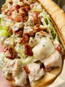 Close up of a Chopped Chicken Bacon Ranch Sandwich showing the creamy ranch sauce and finely diced seared chicken.