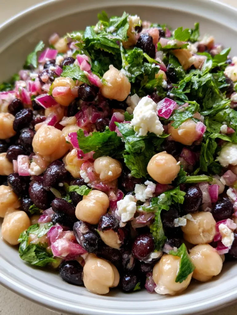 Chickpea and Black Bean Salad with Zesty Lime Dressing 2 Top-down shot of Chickpea and Black Bean Salad showing the contrast between matte black beans and light beige chickpeas.